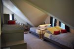 The large attic bedroom has two Queen beds and two twin beds.